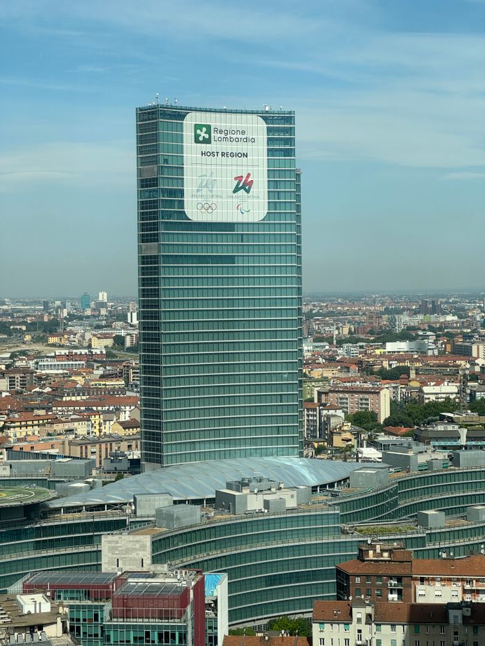 hero-img-02 A scenic view of the Regional Lombardia building in Milan, showcasing its modern architecture against the city skyline.