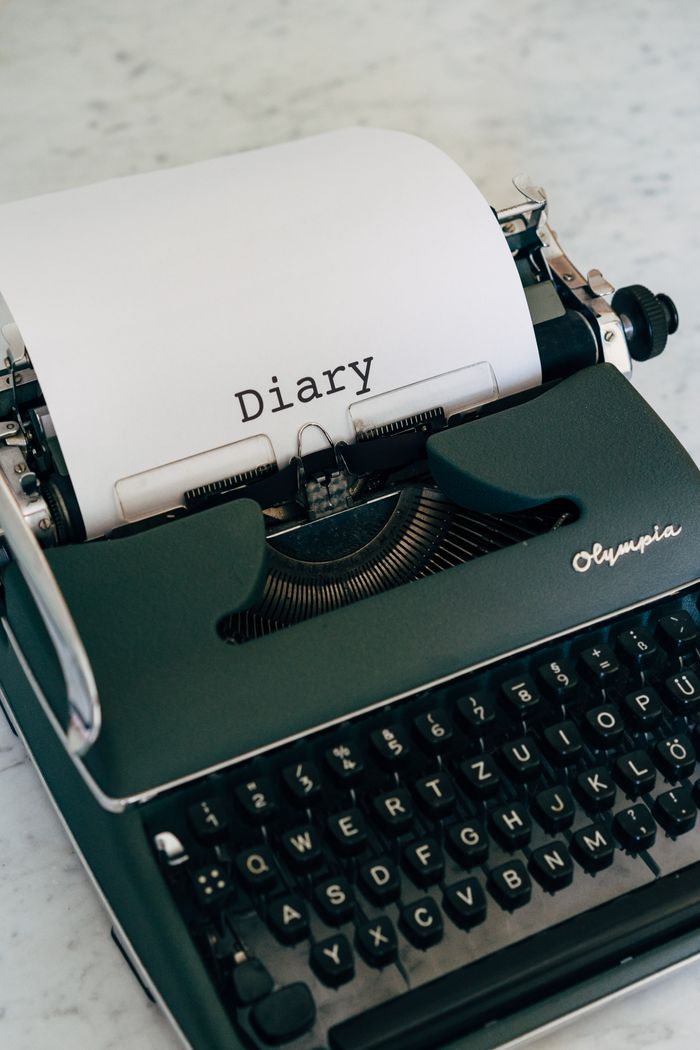 services-02 Classic vintage typewriter with paper showing the typed word 'Diary' in black ink.